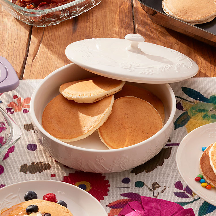 tortilla server with cover open, full of pancakes